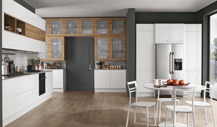 déco moderne dans une cuisine aménagée en blanc gris et bois avec coin salle à manger et grande fenetre