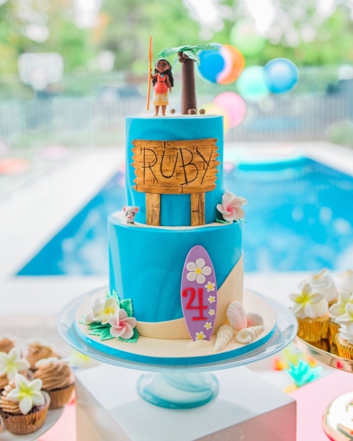decoration anniversaire fille avec un gâteau à deux étages décorés sur le thème Disney avec figurines Vaiana