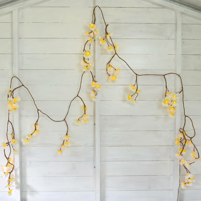 guirlande ampoule en forme de fleurs jaunes et blanches, mur revêtu de bois peint en blanc, guirlande lumineuse pour chambre 