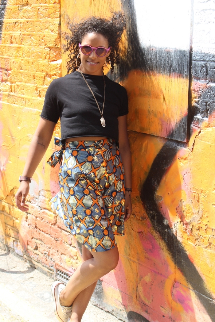 look décontracté en jupe wax à taille haute à motifs gris et orange, combinée avec un simple t-shirt noir