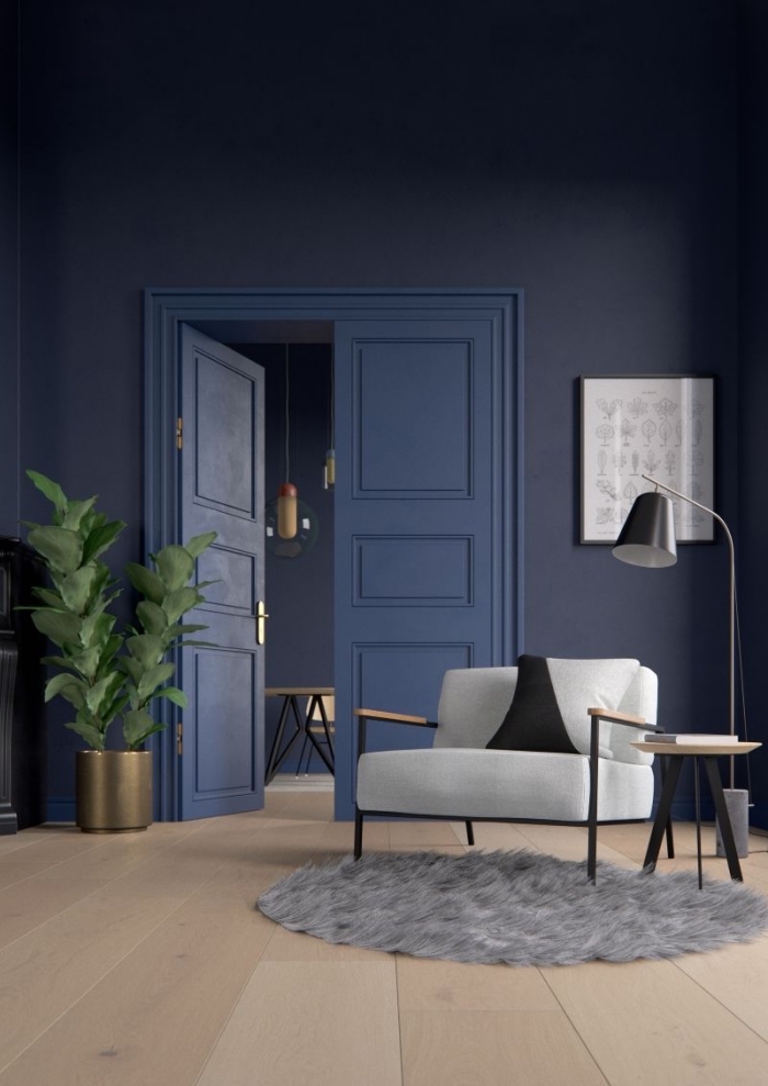 le bleu marine mat des murs et de la porte révèle sa luminosité grâce à quelques accents noir et laiton, fond bleu foncé pour une sensation de profondeur