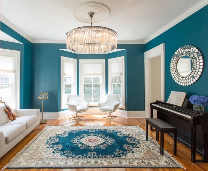 inspiration déco pour un salon bleu paon et blanc d'aspect élégant et classique avec un tapis chic qui reprend les couleurs de l'intérieur