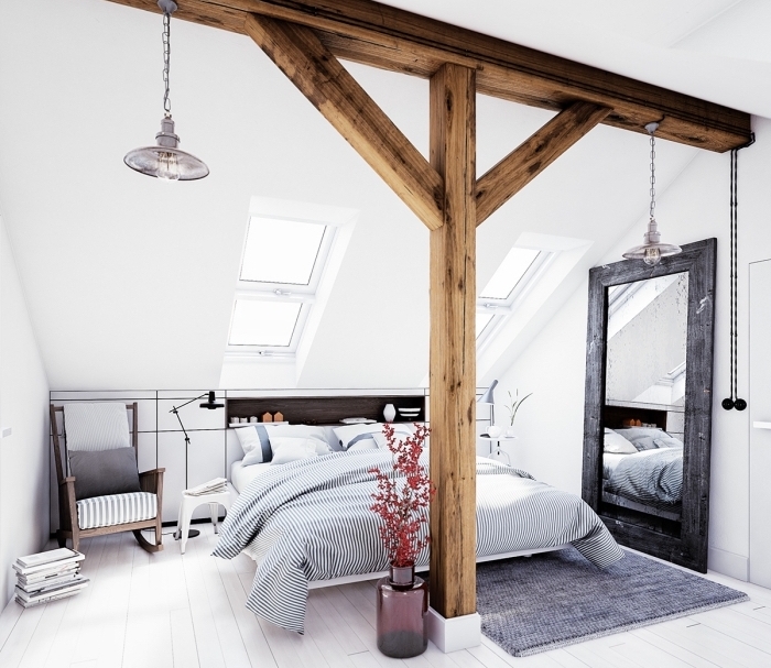 comment décorer une chambre adulte dans l'esprit scandinave avec grand lit et meubles de bois foncé, idée déco avec charpente de bois apparente