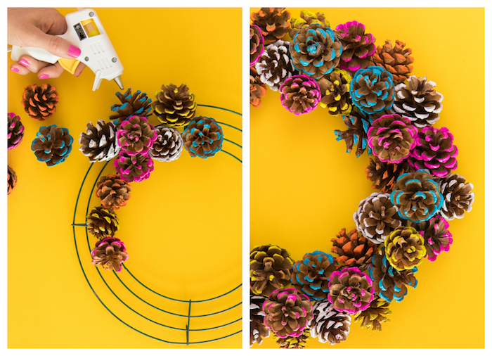 comment faire une couronne de pommes de pin colorées de peinture jaune, rose, blanche et bleue sur un cerceau en fils de fer