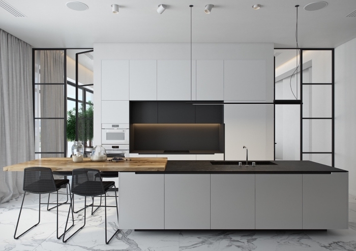 cuisine moderne en gris aux accents noir, avec des armoires à finition mat, ilot central avec table en bois intégrée et zone de lavage