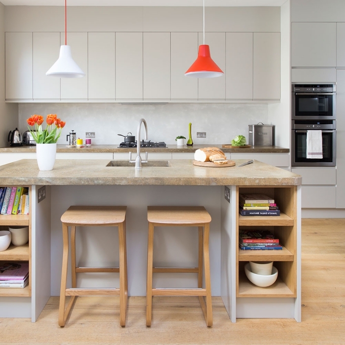 une cuisine gris clair d'esprit scandinave avec plan de travail ilot central en granit contrastant avec la structure de base