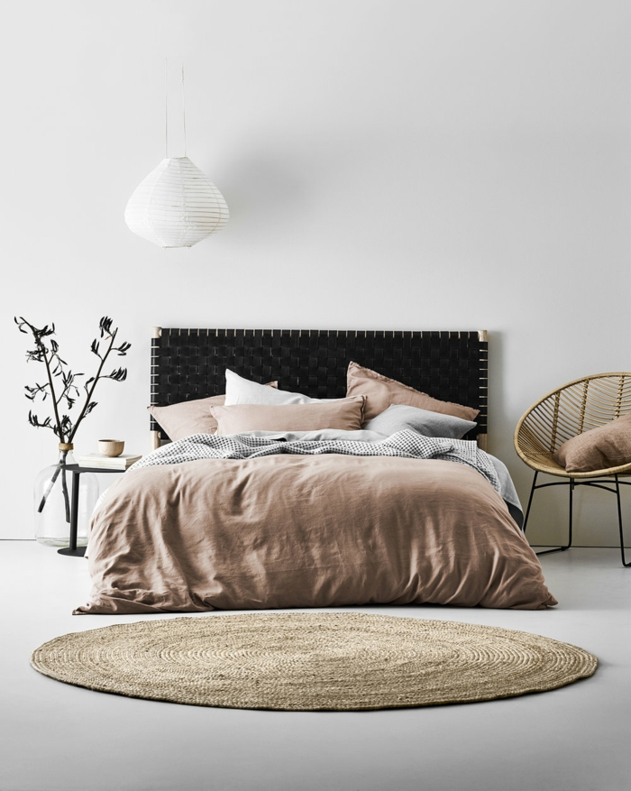 aménagement chambre style scandinave, tapis rond, couverture de lit rose, chaise papasan, lampe suspendue blanche