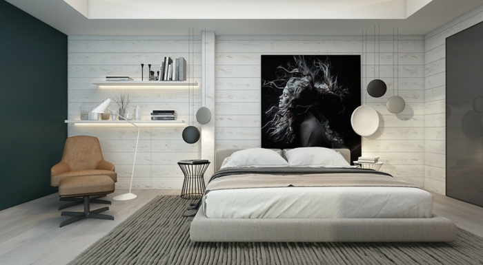 décoration chambre adulte moderne, tapis gris, fauteuil marron, tablettes illuminées, photographie monochrome