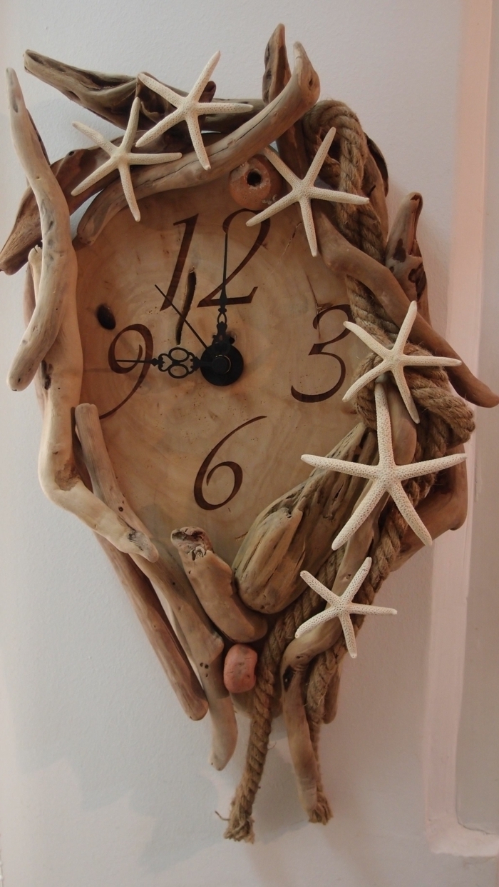 horloge en bois décoré de pièces de bois flotté, étoiles de mer au bord