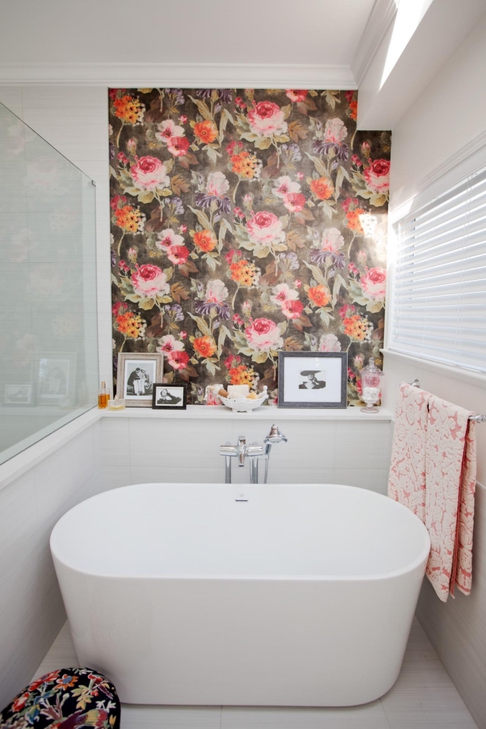 papier peint moderne à design fleuri posé en petite touche au-dessus de la baignoire pour un effet de profondeur dans la petite salle de bains 