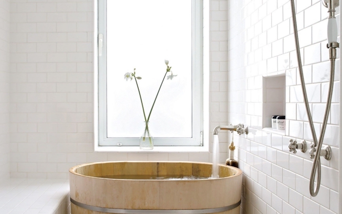 modele de salle de bain aménagée dans esprit minimaliste, déco petite salle de bain avec murs en briques blanches et baignoire japonaise en bois