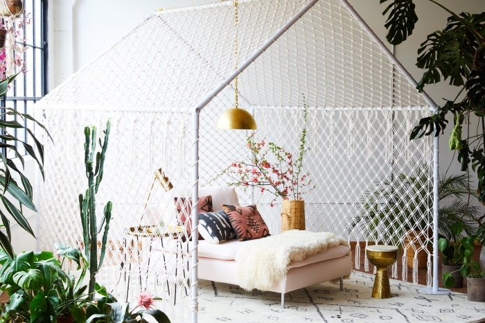 décoration exotique de style jungalow dans un salon blanc aménagé avec meubles de bois et finitions dorées avec plantes vertes, exemple création en macramé