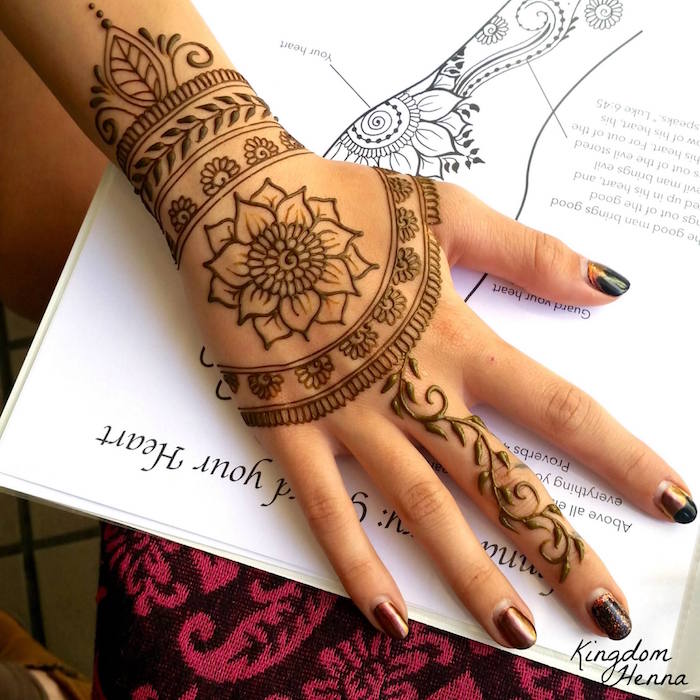 dessin de fleur lotus sur la main et bracelet au henné sur le poignet et doigt