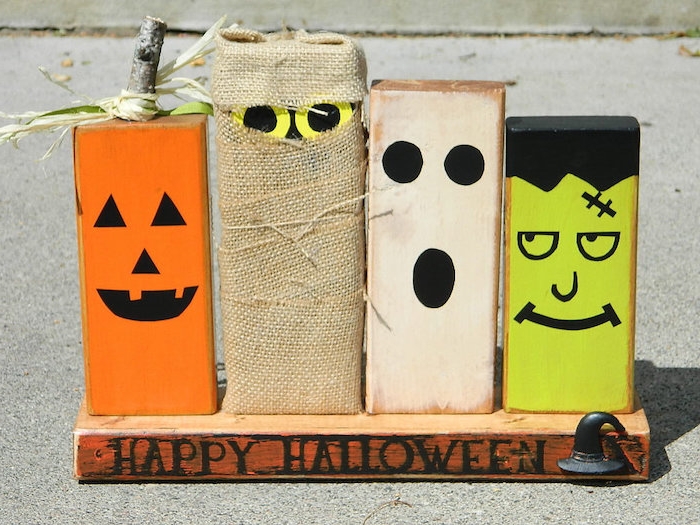 modele deco halloween a faire soi meme, blocks en bois décorés à motif monstre, momie, jack o lantern sur une planche de bois