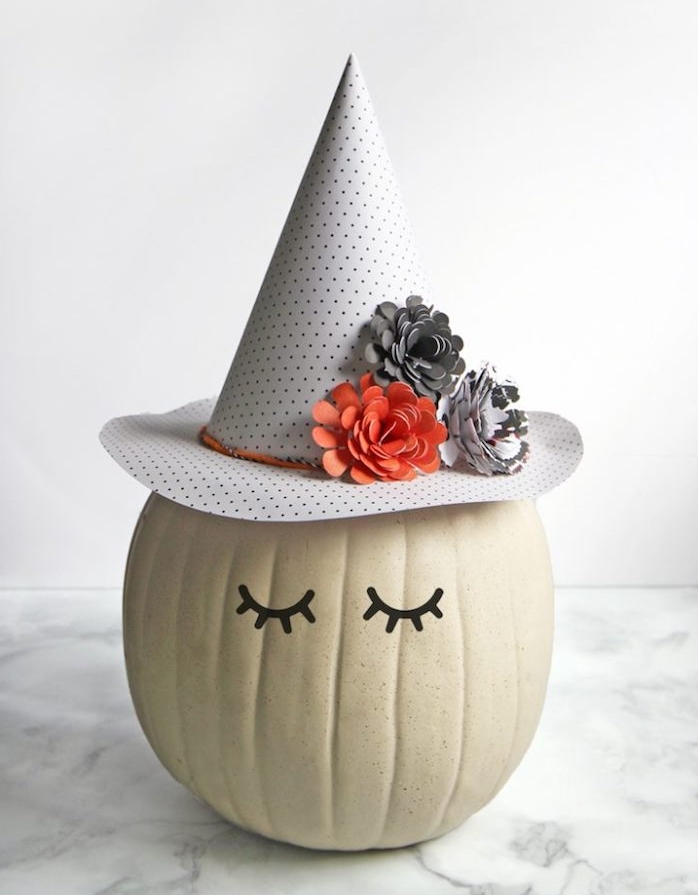 citrouille sorcière fabriqué à partir d une citrouille aux yeux noirs et un chapeau sorcière décorée de fleurs en papier