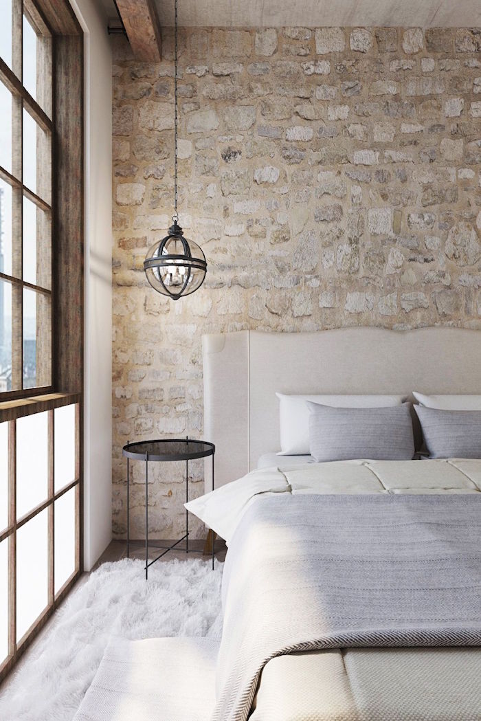 mur de chambre avec pierres ou imitation, cadre de fenetre en bois et lampe suspendue design