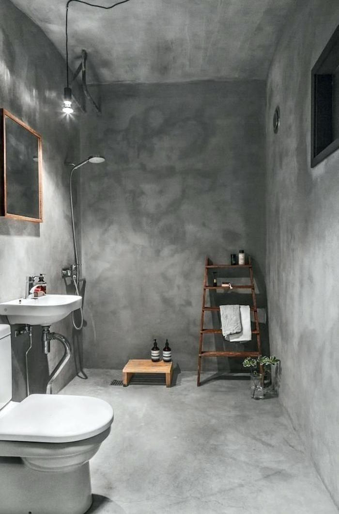 salle e bain avec revetement total ciment gris béton ciré sol mur et plafond avec douche italienne sans carrelage