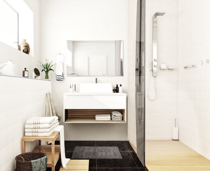 salle de bain type scandinave blanche avec douche italienne à sol en parquet et carrelage noir et vasque design suspendu