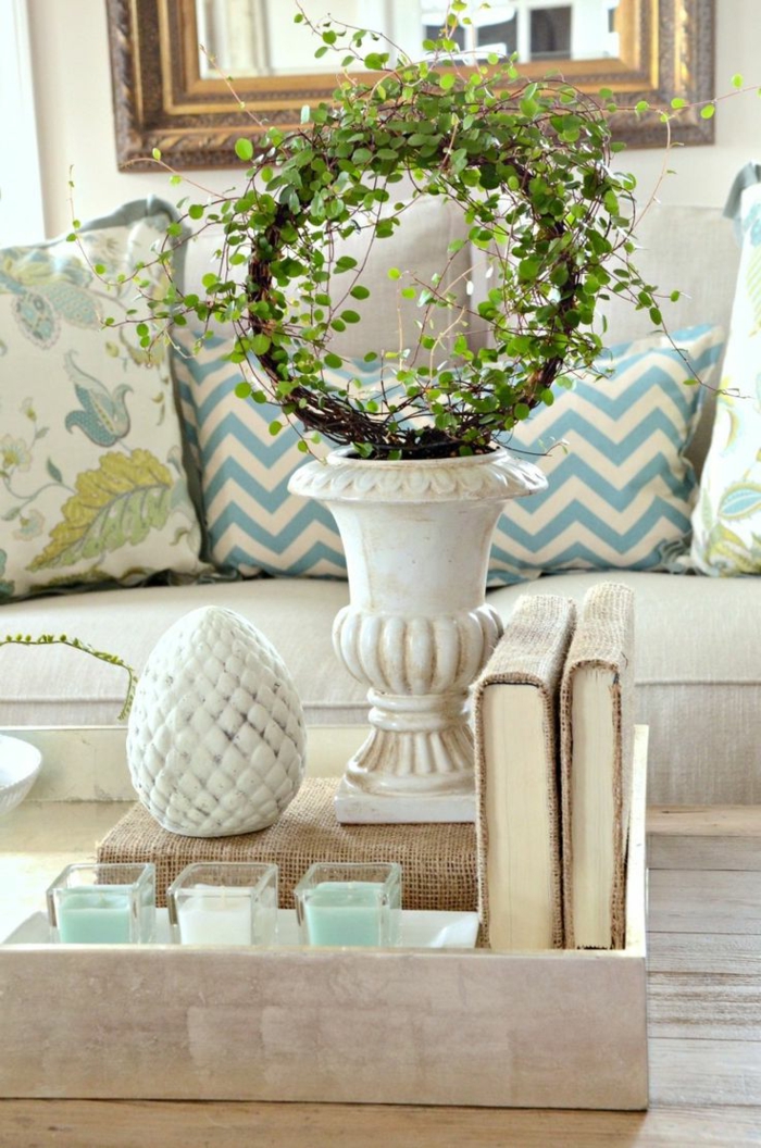vase blanche avec couronne verte, objets déco en forme d'oeuf, petites bougies blanches et turquoises