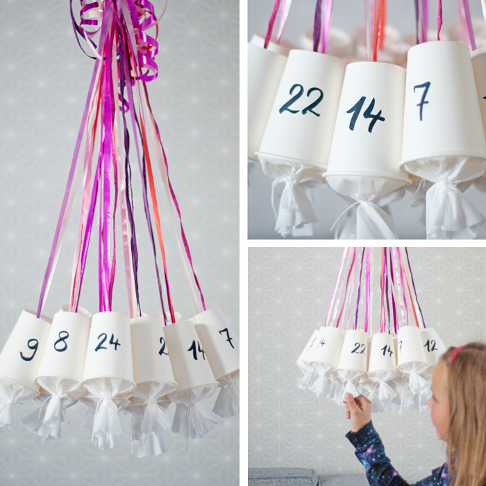 comment fabriquer un calendrier de l avent en gobelets transformés et petits sacs cadeau suspendues sur bandes de ruban colorées