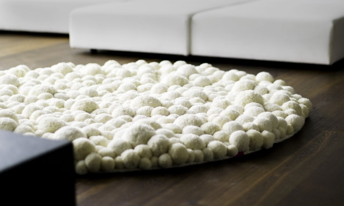 comment décorer un salon avec objet diy cozy, exemple de tapis en pompon blanc à forme ronde pour le salon