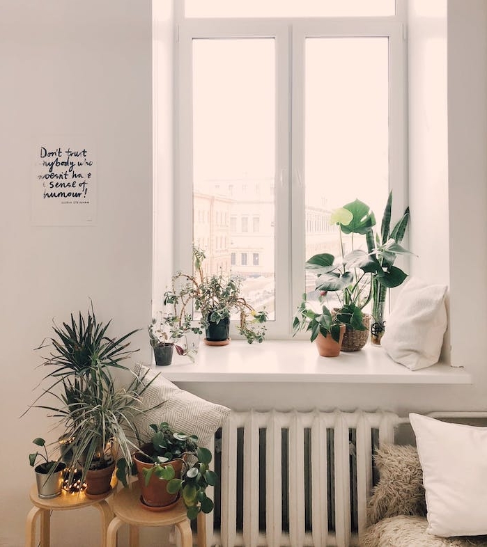 idee deco chambre cocooning, lit décoré de plaid, coussins, plantes en pot vertes, rangées au rebord de la fenêtre et des tabourets de bois