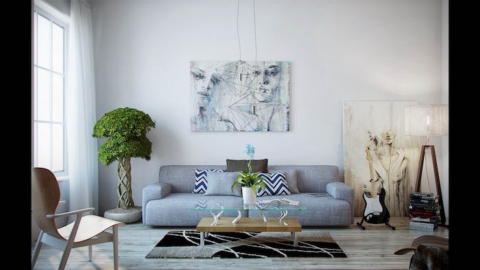 deco salon gris et blanc avec un bonsai arbre dans un coin, canapé gris, table basse bois, tableau d art en deco murale, chaise bois et parquet bois clair, murs blancs