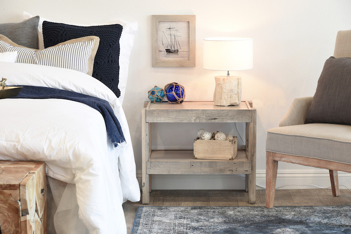 diy table originale, meuble en palette planches de bois brut avec decoration style bord de mer, tapis vintage, linge de lit bleu, gris, blanc