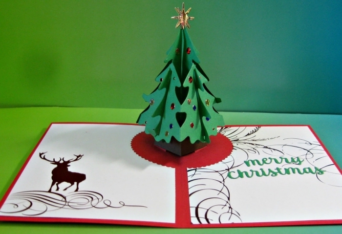 réalisation carte de Noel, exemple d'activité manuelle avec papier, modèle de carte avec sapin pop up décoré en strass coloré et étoile scrapbooking dorée