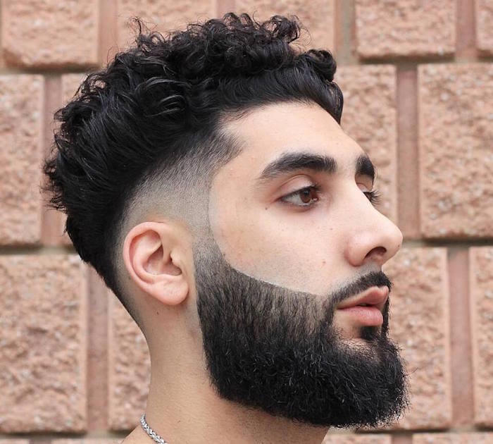 homme brun oriental avec coupe tendance dégradé tres court bas autour des oreilles et cheveux bouclés et longue barbe noire taillée