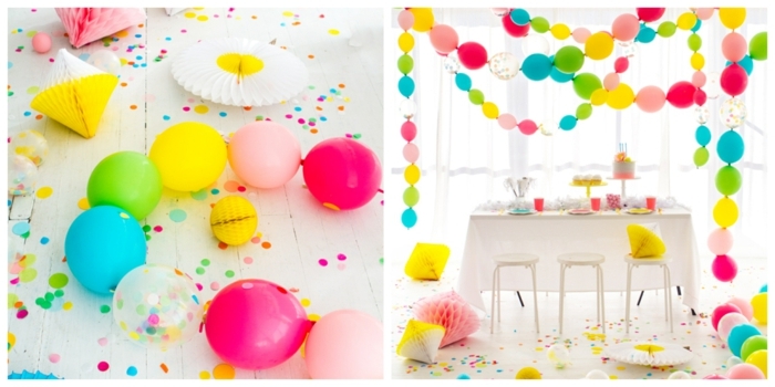 pièce blanche avec guirlandes de ballons flottants aux couleurs vives, paillettes, table et tabouret blancs