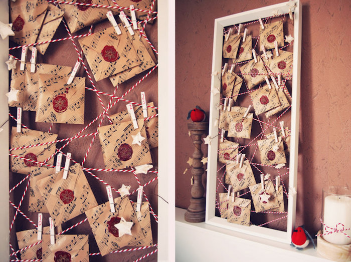 cadre bois avec de petits sachets motif notes musicales sur fil rouge et blanc suspendus sur des pinces à linge bois