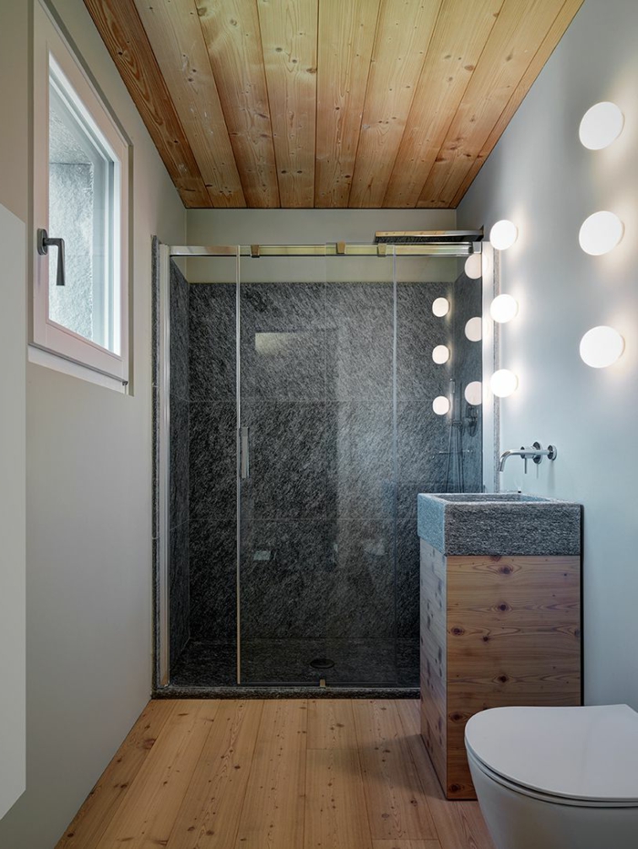 salle de bain italienne bois et gris, vasque colonne en bois, plafond en bois, lampes murales, sol en planches de bois