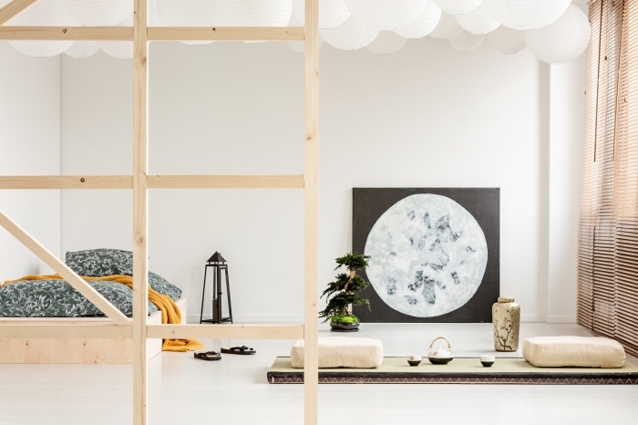 déco minimaliste dans une chambre à coucher scandinave aux murs blancs aménagée avec meubles en bois clair