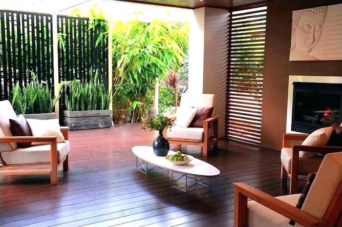 salon de jardin extérieur sur terrasse en parquet avec déco exotique et claustra en bois étroite d'intérieur comme séparation avec extérieur