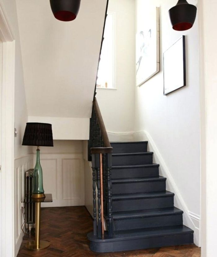 repeindre un escalier en bois tout en noir pour la mettre en valeur dans une cage d'escalier blanc de style scandinave