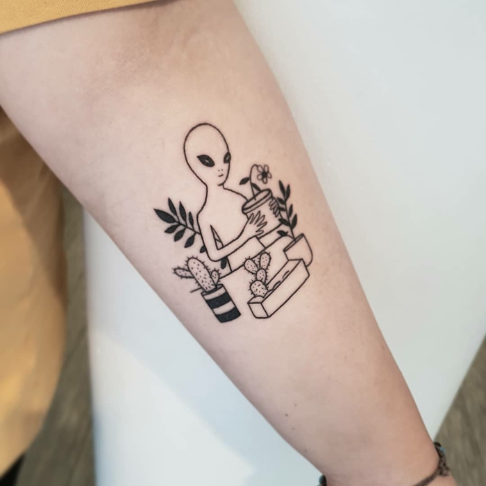 Tatouage fleur modele de tatouage cool idée originale pour un tatouage mignon avec un extraterrestre qui plante des plantes 