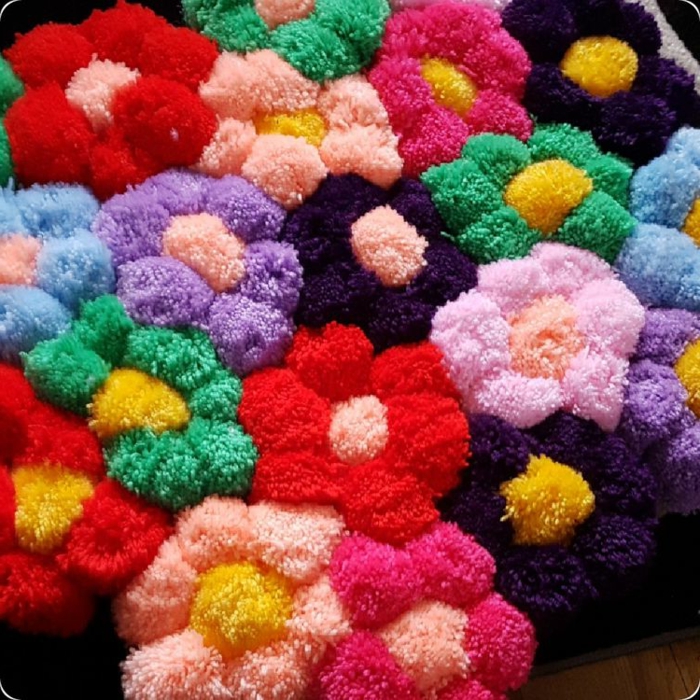 un jardin fleuri en pompons multicolores, tapis pompon aux motifs fleurs, faire des pompons pour tapis