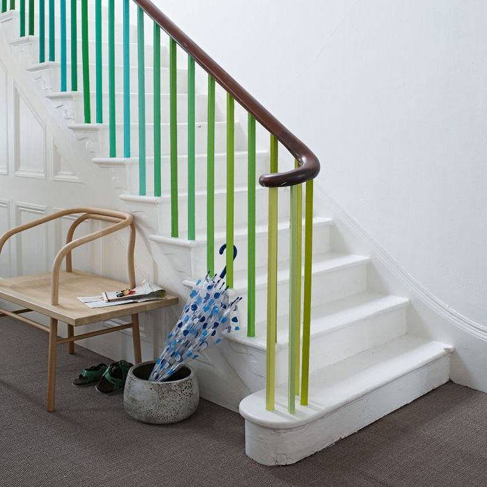relooker un escalier en bois en peignant les barres du garde-corps en camaïeu de bleus et de verts qui sont en joli contraste avec les marches et les murs blancs