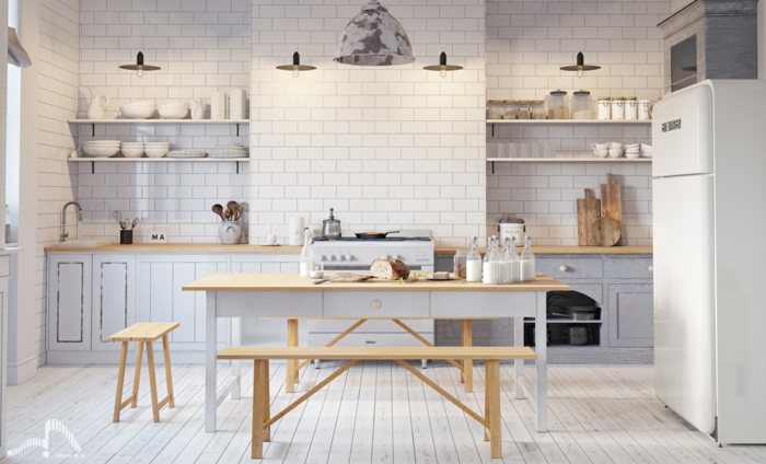 cuisine scandinave en bois et blanc, quatre lampes pendantes, table de repas et banquettes, placards couleur claire 