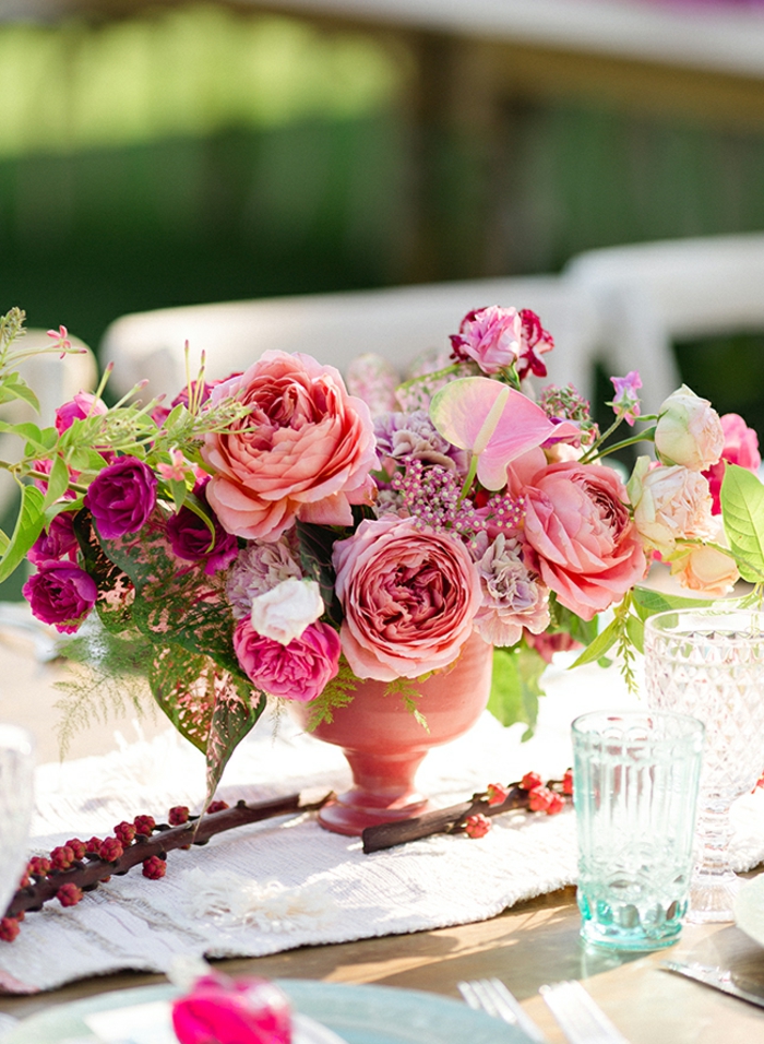 vase rose avec fleurs, chemin de table lin, table de fête en bois, verre turquoise en verre, chaises blanches