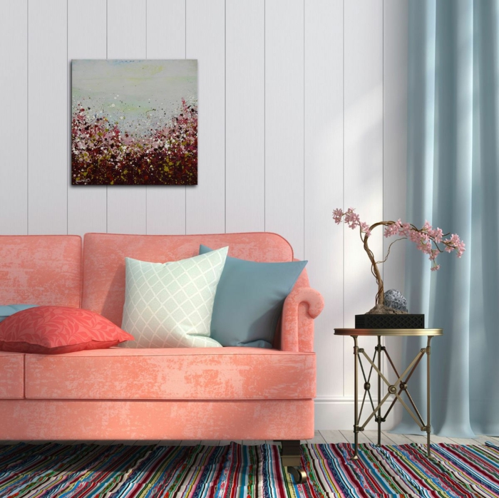 sofa rose saumon, tapis rayures, table de chevet dorée, tableau peinture artistique, bonsai aux fleurs roses