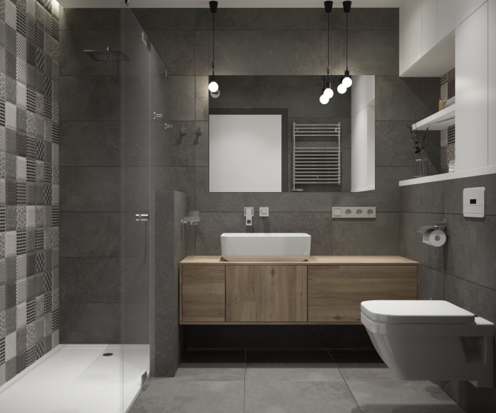 modèle de salle de bain grise avec meubles haut rangement mural en blanc, cabine de douche avec carreaux blanc et gris