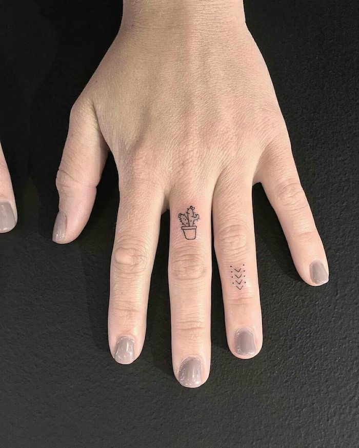 tatouage doigt majeur minimaliste, dessin cactus et flèche au design subtil 