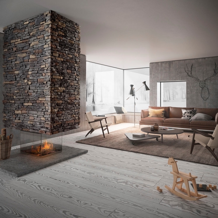 idée aménagement salon avec mur en pierre, design intérieur salon gris et bois avec peinture effet beton ciré