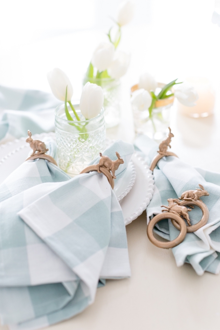 décoration de table de pâques avec des serviettes en tissu à carreaux et leurs ronds de serviette décoratifs lapins 