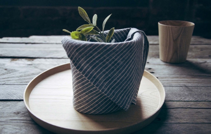 serviette en tissu graphique pliée en petit panier, modèle de pliage origami paques facile et rapide pour décorer une table de style rustique