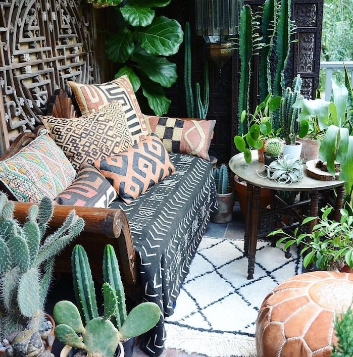 idee de deco balcon avec canapé et coussins decoratifs motif exotique, plantes grasses d extérieur, deco boheme style jungle urbain, pouf marron