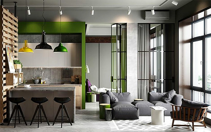 appartement gris aux accents verts, lampes pendantes suspendues, fauteuils gris, plafond en béton, coin cuisine style industriel