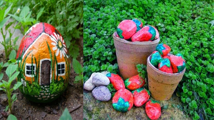 pots de fleurs remplis de galets peints comme fraises, galet dessiné maison posés dans le parterre de jardin